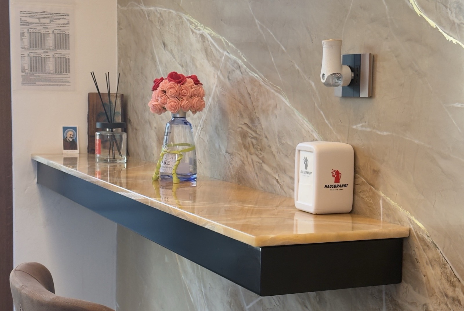 A corner of the bar: a marble shelf with flowers
